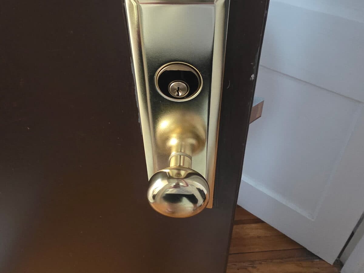 Brass deadbolt and handle set on a residential front door
